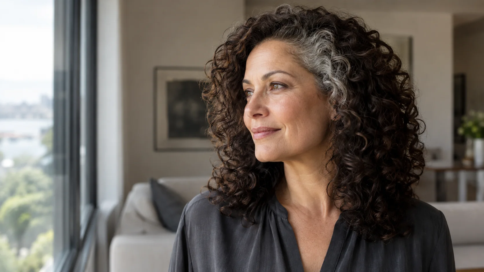 Localized natural silver temple curls against dark brunette hair